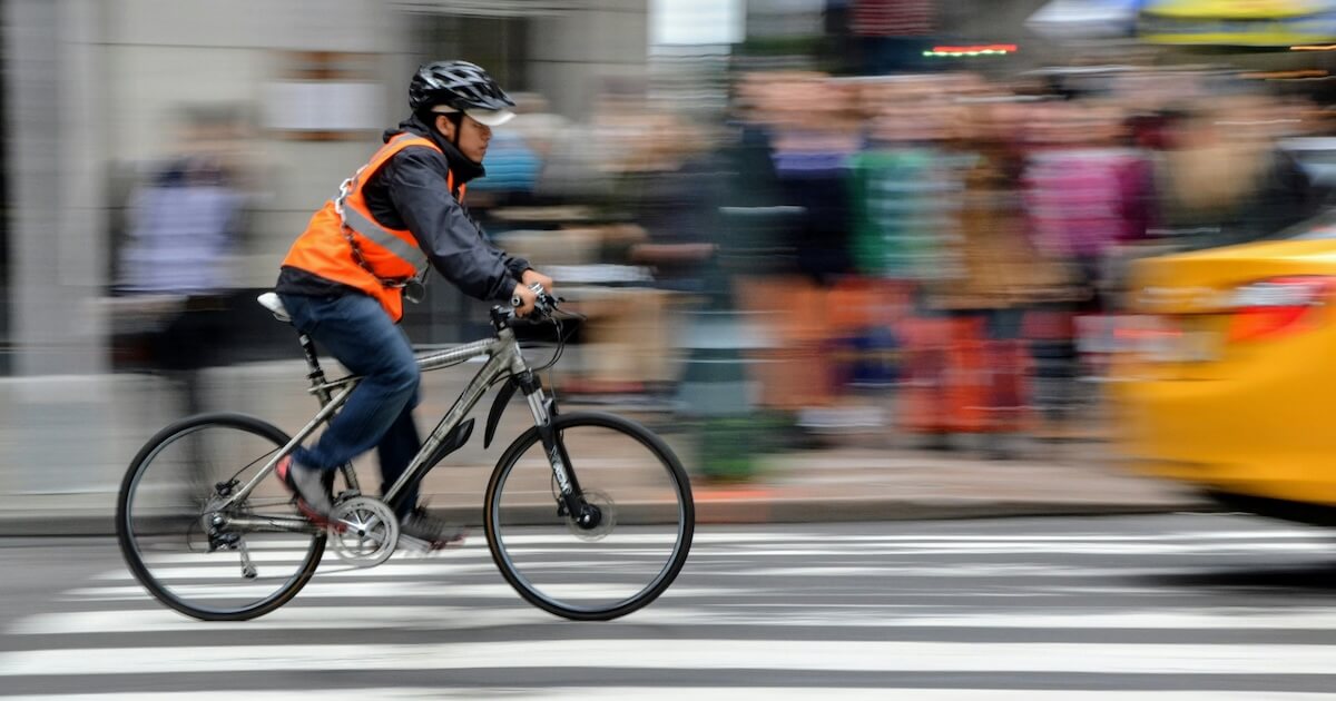 Cyclist riding with reflective gear safely