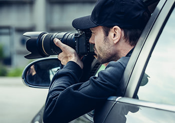 Our law firm hires private investigators like this man, using a telephoto lens to photograph someone from a distance.