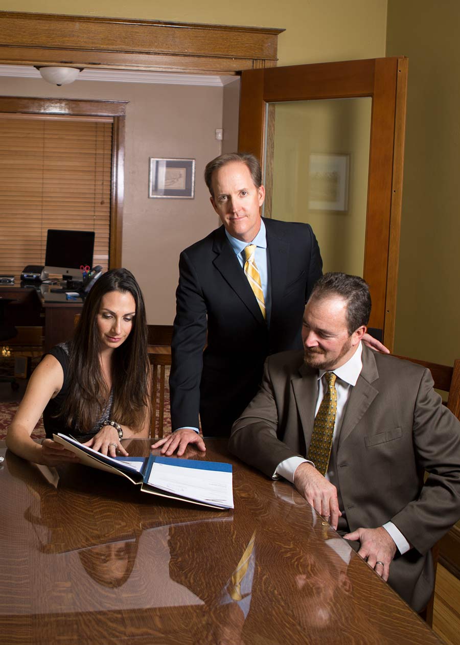 Scott O'Sullivan in an office with his team members