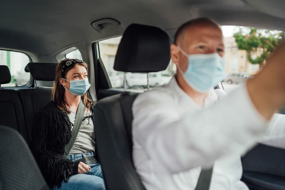 person taking a Lyft in denver with masks on
