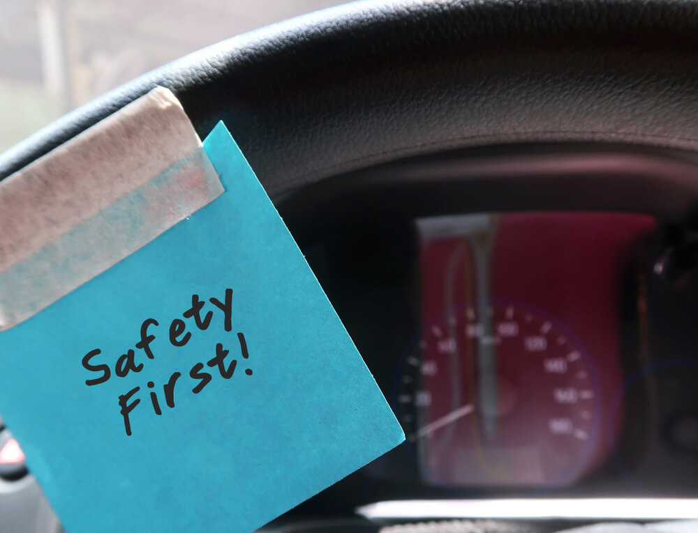 Safety first post-it on a car dashboard, reminding Colorado drivers to be safe.