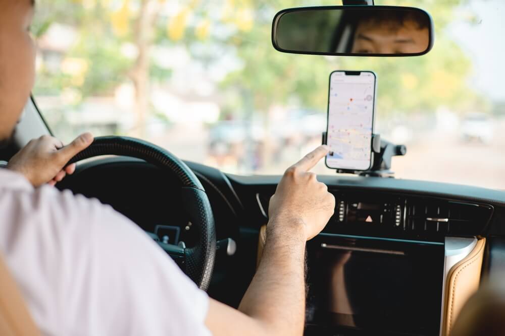 Teen using navigation app in car.
